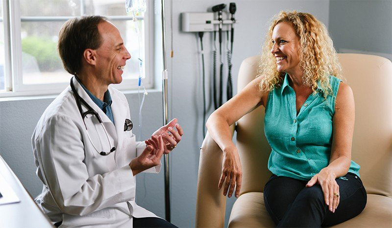 Dr. Mark Stengler advising a patient in his clinic